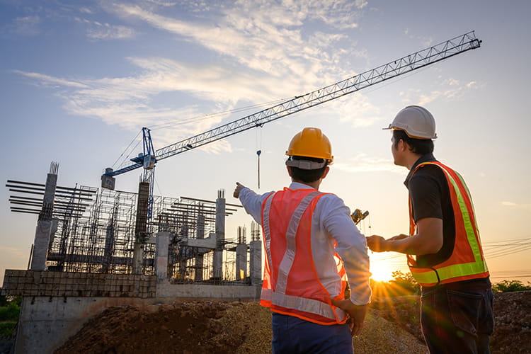 Two construction workers on a job site